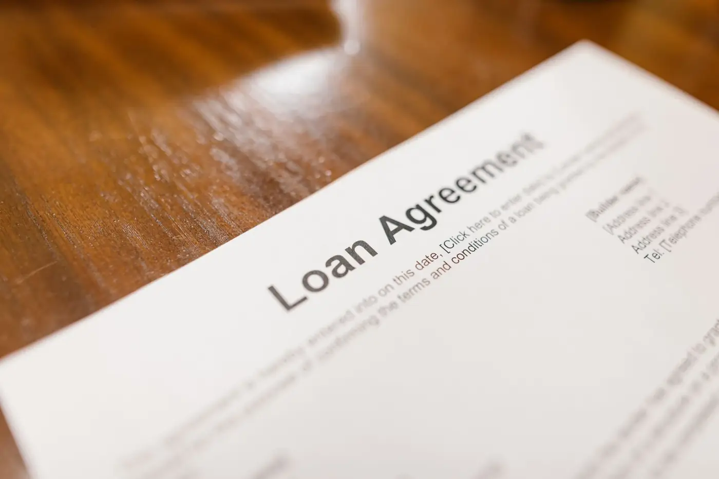Acknowledgement of Debt in Dubai 1 A printed loan agreement lying on a polished wooden table