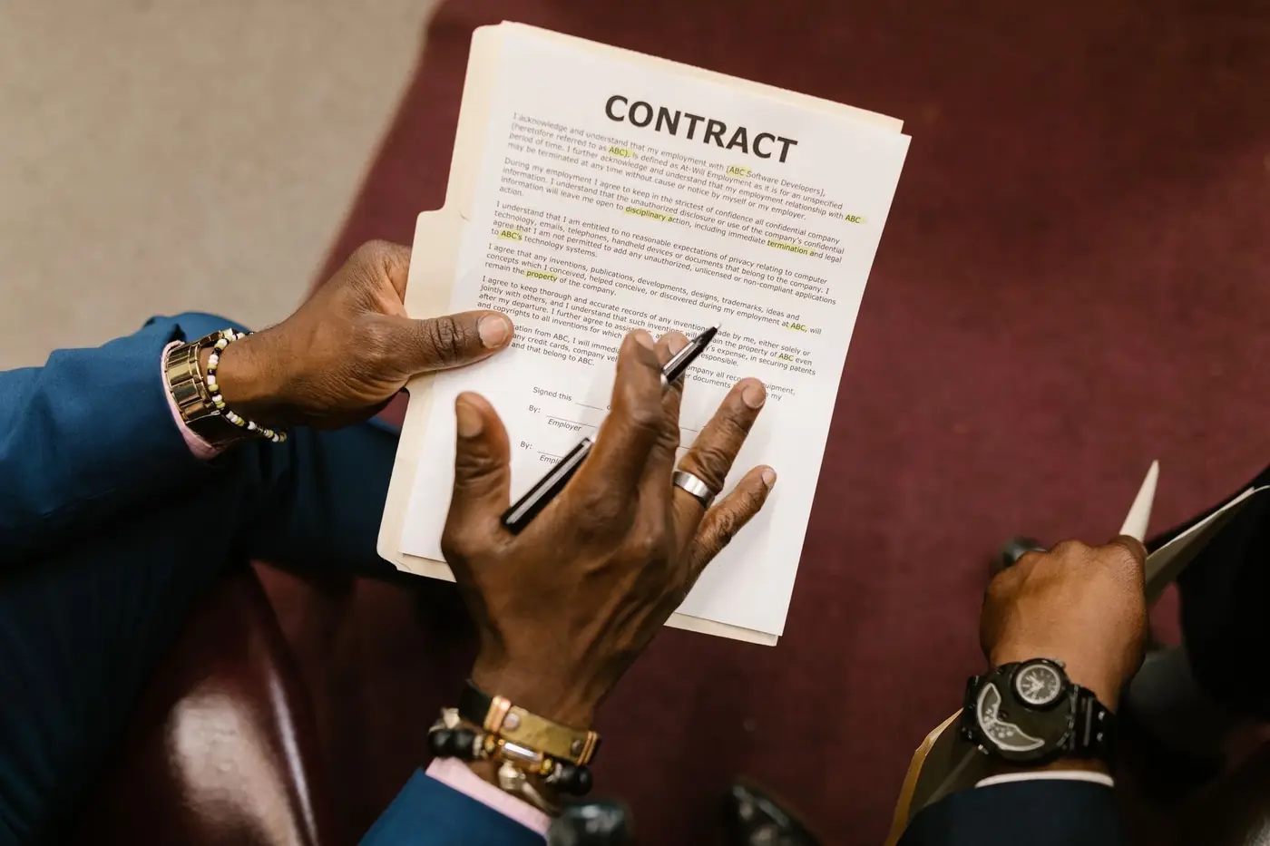 MOA Amendment in the UAE: Addendum to MOA 1 A man holding a contract and a pen during a meeting