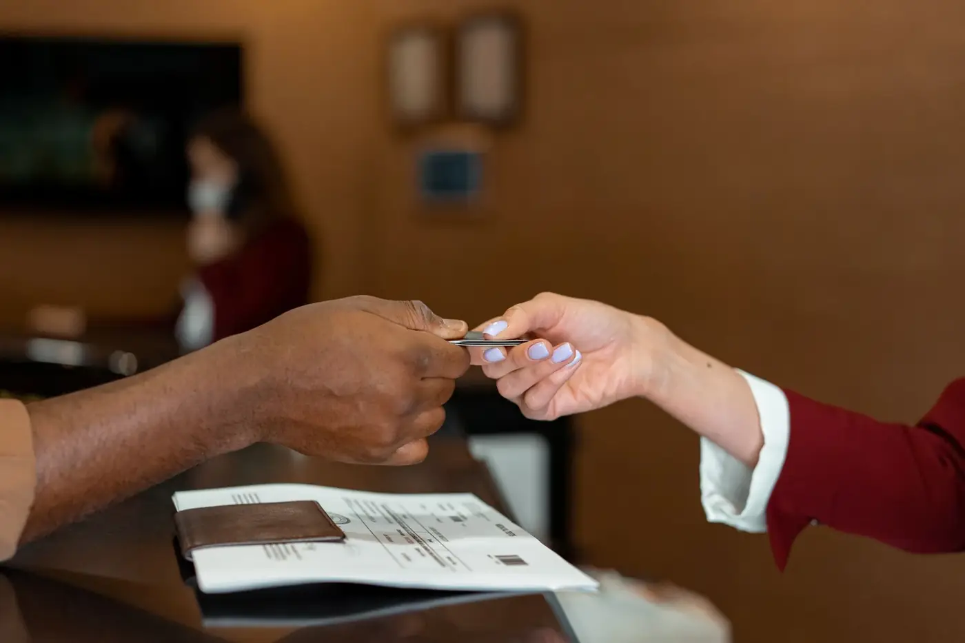 Acknowledgement of Debt in Dubai 5 A card being handed across a counter above a passport and papers