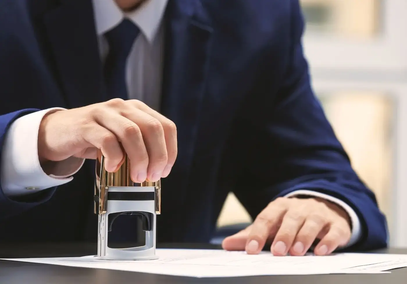 E-notary in Dubai and the UAE, explained step by step 1 A man in a suit stamping a document