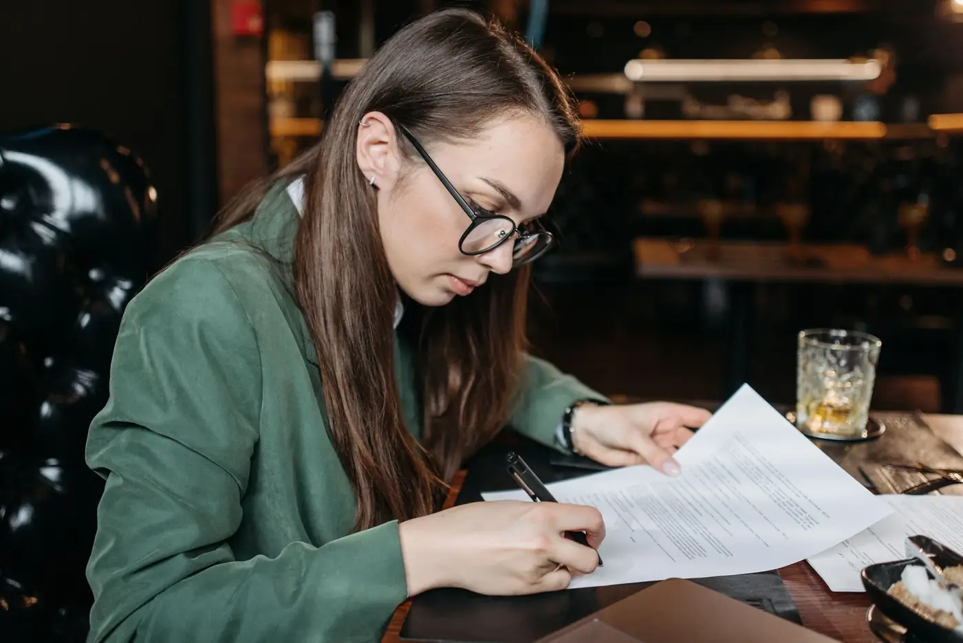 A woman reading and signing a written statement