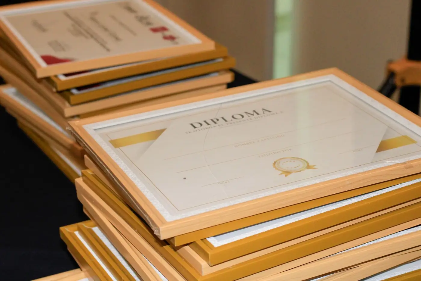 Degree Certificate Attestation for the UAE, Explained 2 Framed degree certificates stacked on a table