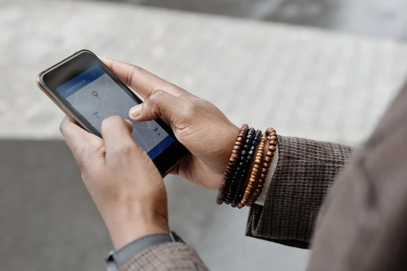 Notary Public Near Me in Dubai: Get Documents Notarised Nearby 1 Hands holding a smartphone showing a map with a location pin