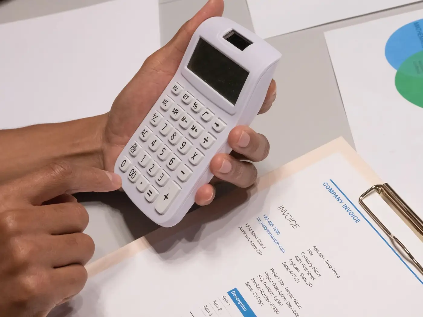 Notary public fees in Dubai: what you pay and why 1 Hands holding a calculator over an invoice on a clipboard