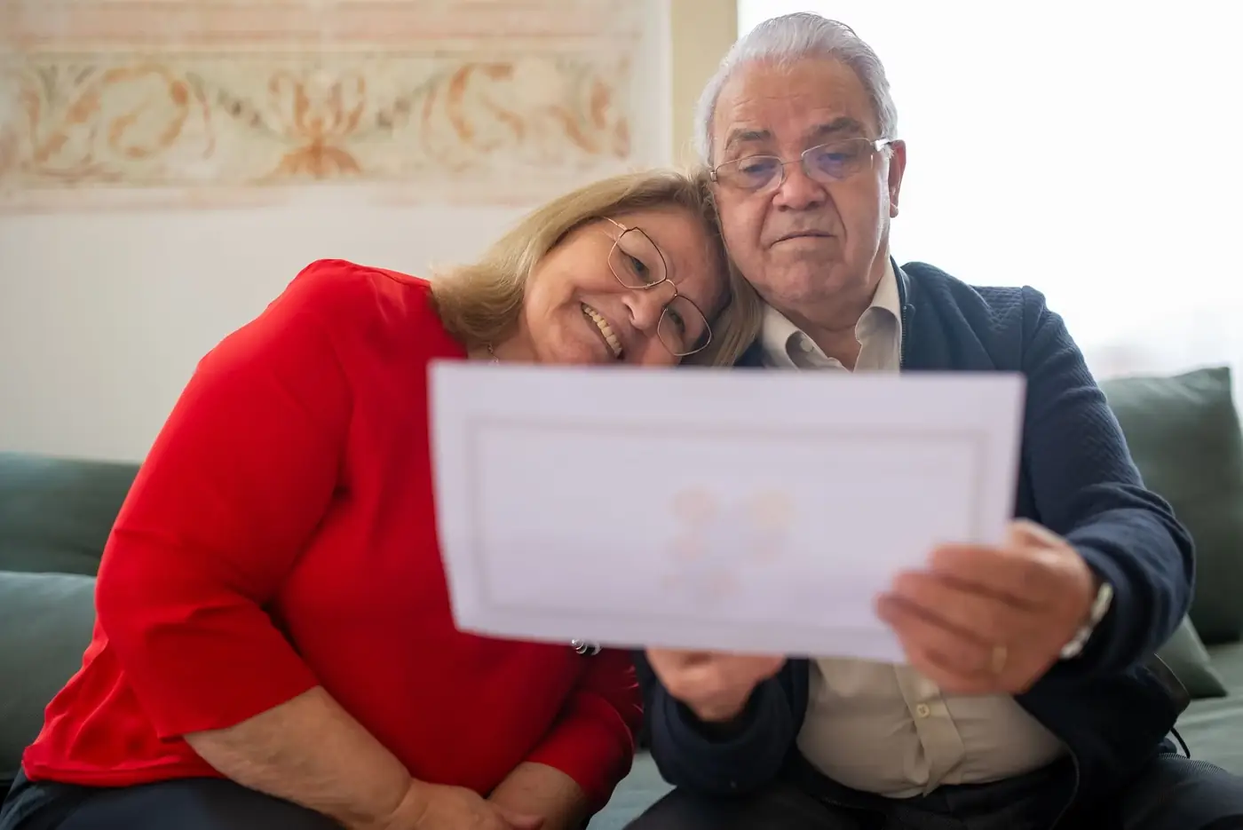Power of Attorney for Inheritance in the UAE 1 An older couple on a sofa reading a document together